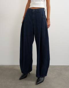Model wearing Cocoon mid rise barrel jean in dark rinse