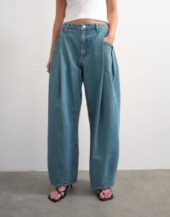 Model wearing Cocoon mid rise barrel jean in green cast