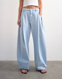 Model wearing Cocoon mid rise barrel jean in super bleach