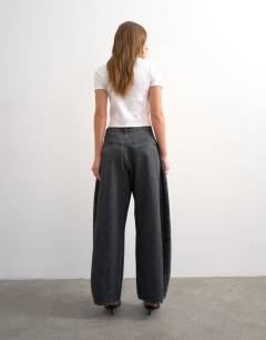 Model wearing Cocoon mid rise barrel jean in washed black