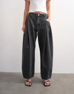 Model wearing Cocoon mid rise barrel jean in washed black