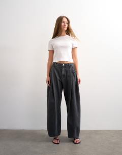 Model wearing Cocoon mid rise barrel jean in washed black