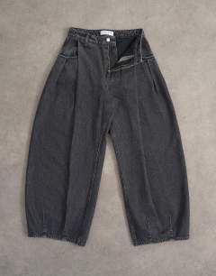 Model wearing Cocoon mid rise barrel jean in washed black