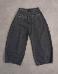 Model wearing Cocoon mid rise barrel jean in washed black