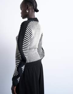 Model wearing Cocoon plated ribbed jumper in black and white