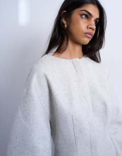 Model wearing Cocoon structured mini dress in woven grey marl