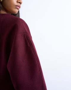 Model wearing Cocoon structured mini dress in woven port royale