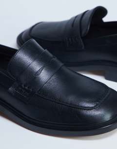 Model wearing Cole premium real leather square toe loafers in black