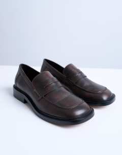 Model wearing Cole premium real leather square toe loafers in distressed brown