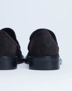 Model wearing Cole Premium suede loafer in chocolate