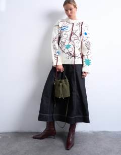 Model wearing Colette real suede bucket bag in khaki