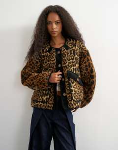 Model wearing Collareless cord fleece jacket in animal print