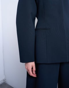 Model wearing Collarless structured blazer in navy