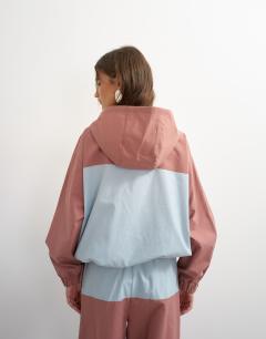 Model wearing Colour block bomber in blue and mauve 