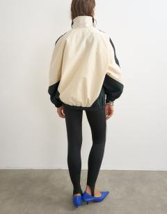 Model wearing Colour block funnel neck jacket in ecru
