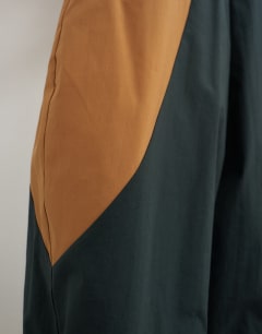 Model wearing Colour block horseshoe trouser in brown and black