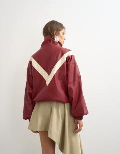 Model wearing Colour block leather look track jacket in red
