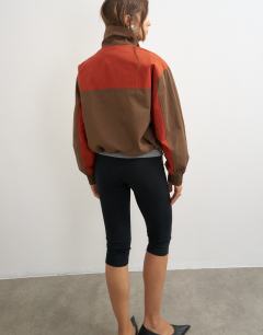 Model wearing Colour block pocket detail zip up jacket in brown and red