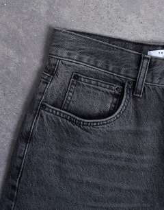 Model wearing Column low rise relaxed fit jean circular design in washed black