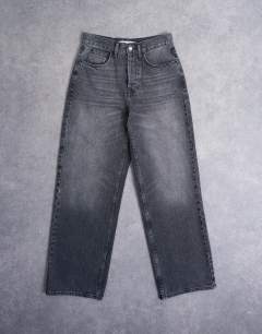 Model wearing Column low rise relaxed fit jean circular design in washed black