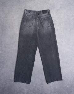 Model wearing Column low rise relaxed fit jean circular design in washed black