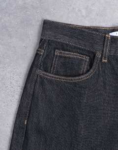 Model wearing Column mid rise jean in black ecru