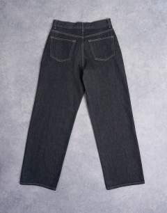 Model wearing Column mid rise jean in black ecru