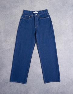 Model wearing Column mid rise jean in indigo rinse