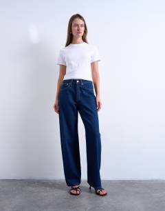 Model wearing Column mid rise jean in indigo rinse
