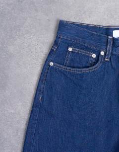 Model wearing Column mid rise jean in indigo rinse