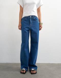 Model wearing Column mid rise jean in rich blue