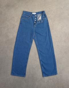 Model wearing Column mid rise jean in rich blue