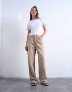 Model wearing Column mid rise jean in washed beige