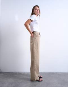 Model wearing Column mid rise jean in washed beige