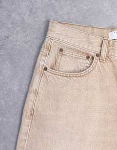 Model wearing Column mid rise jean in washed beige
