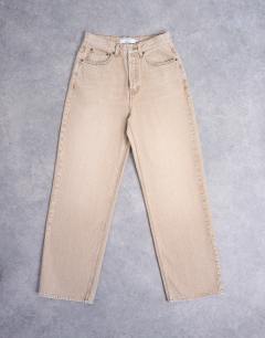 Model wearing Column mid rise jean in washed beige