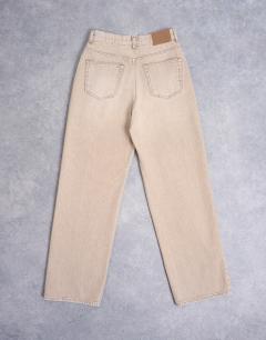 Model wearing Column mid rise jean in washed beige