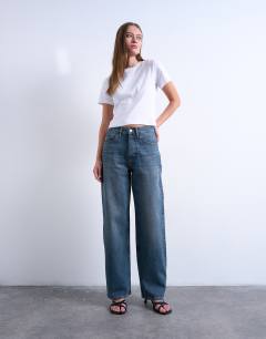 Model wearing Column mid rise jeans in deep blue