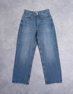 Model wearing Column mid rise jeans in deep blue