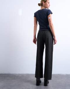Model wearing Column mid rise straight jean in black stripe