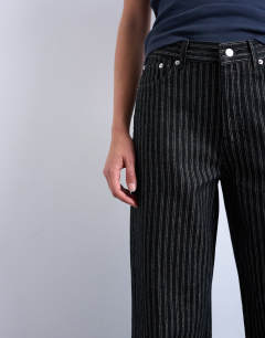 Model wearing Column mid rise straight jean in black stripe