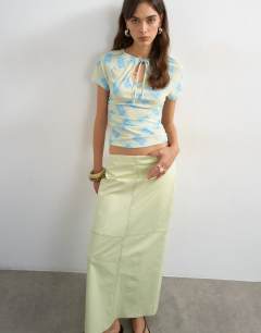 Model wearing Column midi skirt with contrast stitch detail in light green