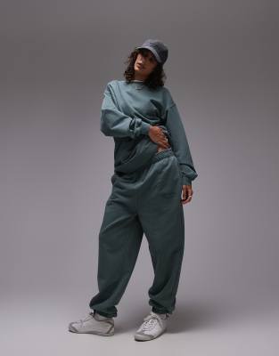 community graphic cuffed sweatpants in green - part of a set