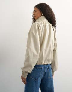 Model wearing Contrast piping track jacket in cream