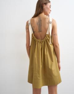 Model wearing Contrast stitch tape detail smock mini dress in light khaki