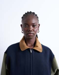 Model wearing Contrast suede varsity bomber jacket in multi
