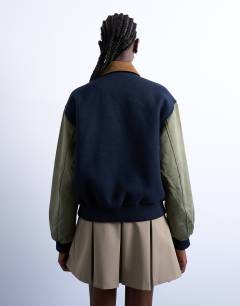 Model wearing Contrast suede varsity bomber jacket in multi