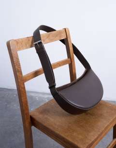 Model wearing Cooper cross body real leather bag in chocolate