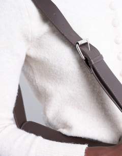 Model wearing Cooper cross body real leather bag in chocolate