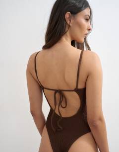 Model wearing Cooper square neck swimsuit in chocolate